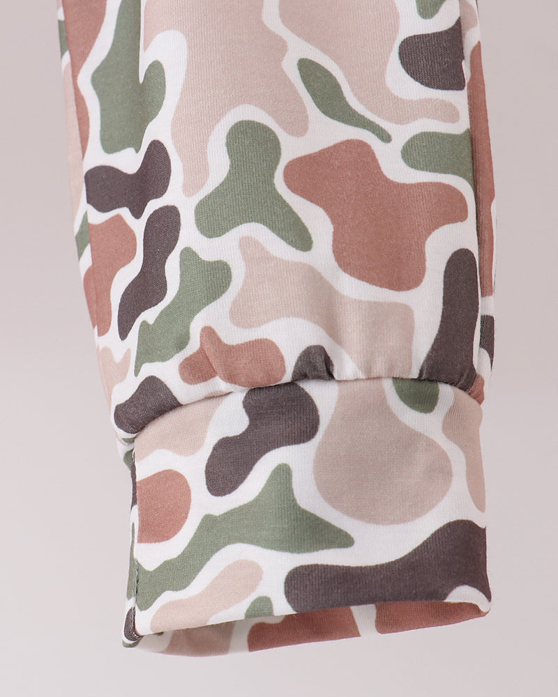 Camouflage pants fabric with multicolor woodland print, folded hem detail