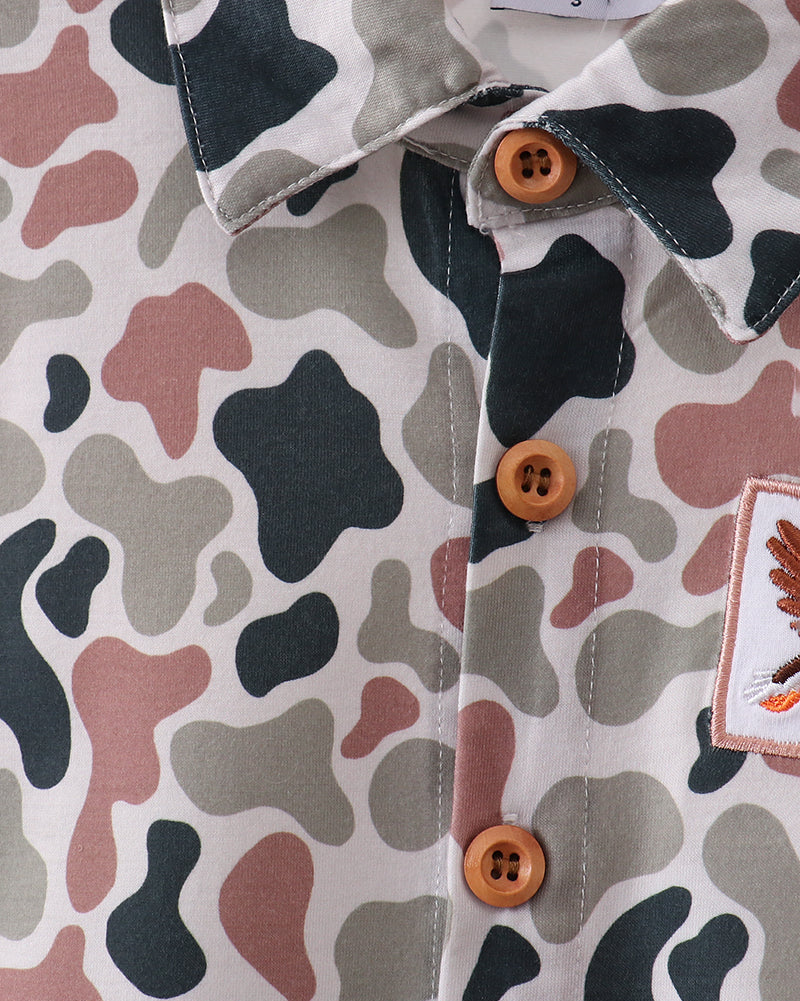 Close-up of a patterned shirt with buttons and a label.