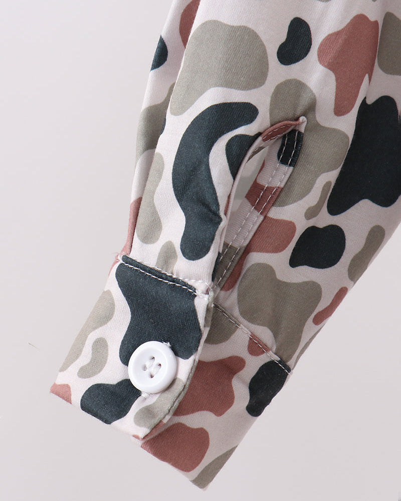 Camouflage-patterned shirt with a button on a light gray background