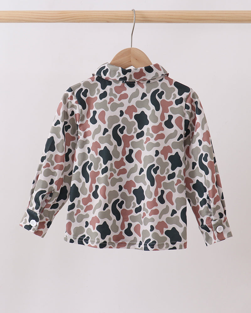 Camouflage-patterned shirt on a hanger against a white background