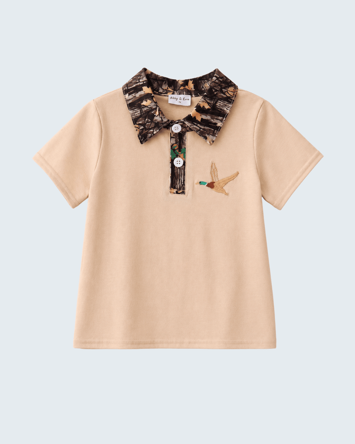 Beige polo shirt with camouflage collar and duck design on a light blue background
