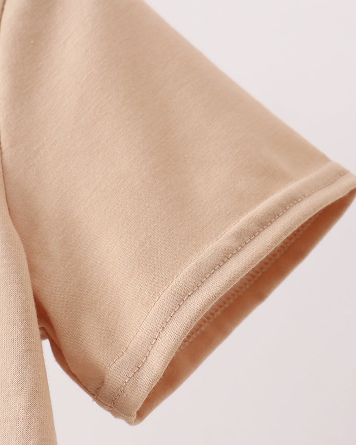 Close-up of beige fabric with a plain background