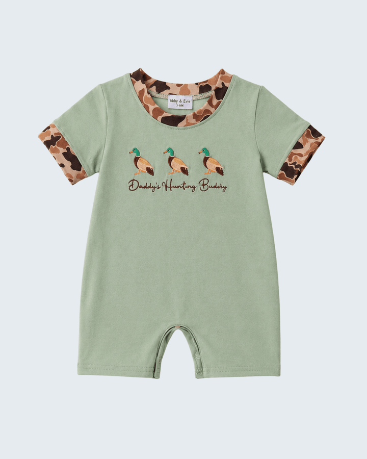 Green baby romper with camouflage sleeves and duck design on a light gray background
