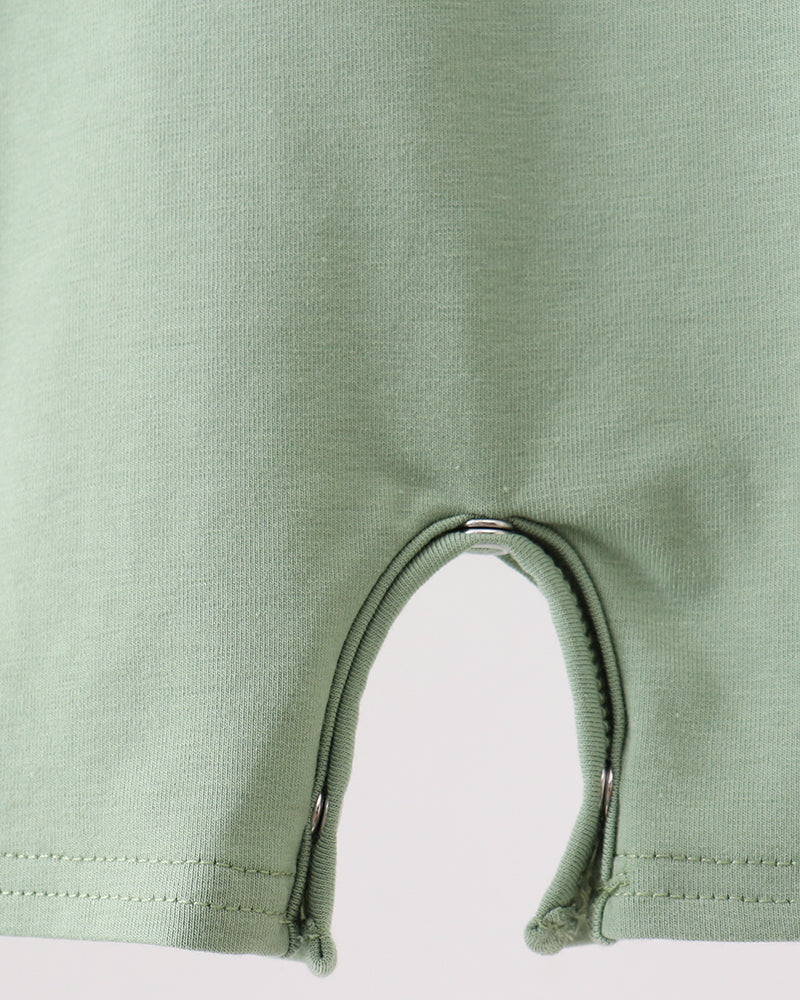 Close-up of a green baby romper with a zipper on a white background