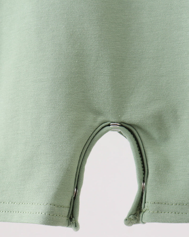 Close-up of a green baby romper with a zipper on a white background