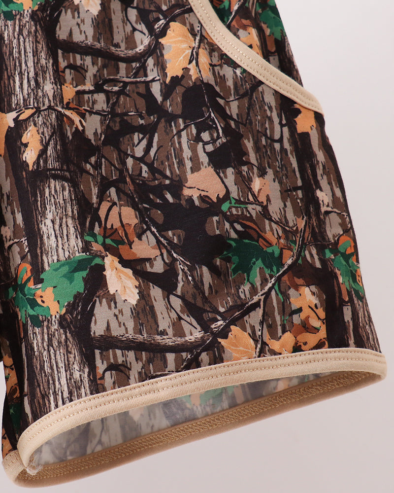 Camouflage-patterned fabric with a neutral border on a white background