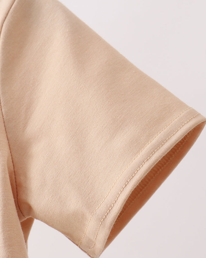 Close-up of beige fabric with a plain background