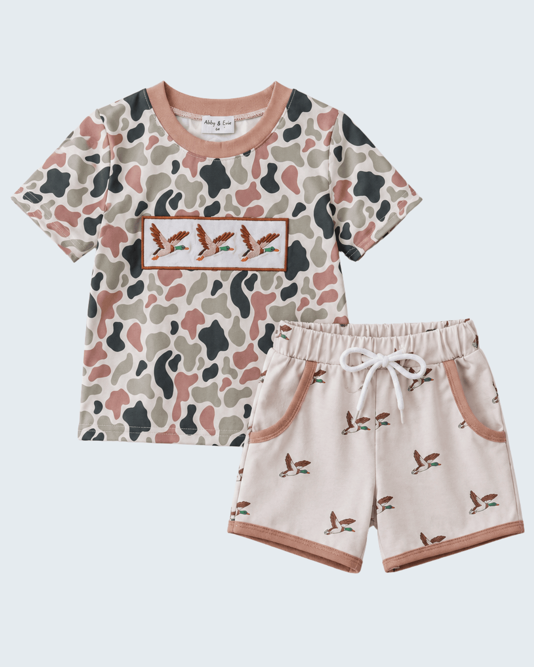 Children's outfit with patterned shirt and shorts on a light gray background