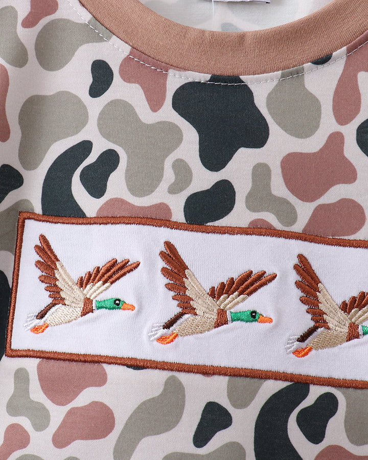 Camouflage-patterned fabric with embroidered duck design