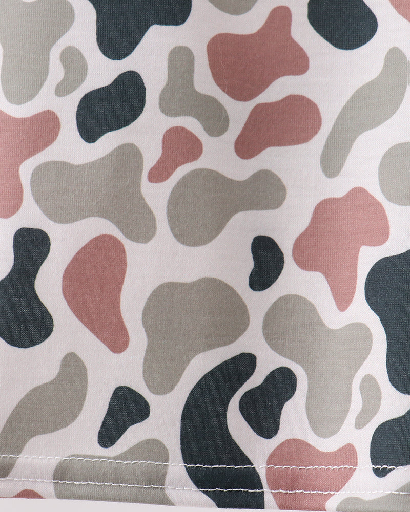 Close-up of fabric with camo pattern in black, red, and gray on a white background