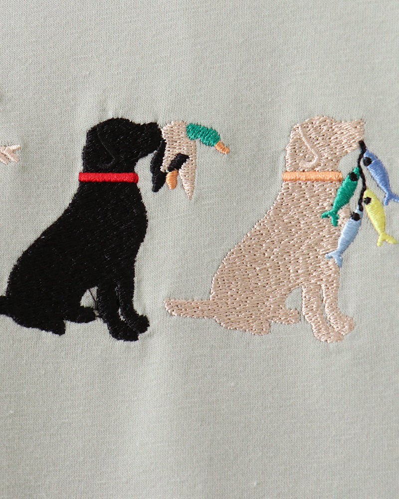 Embroidered design of two dogs with toys on a gray background