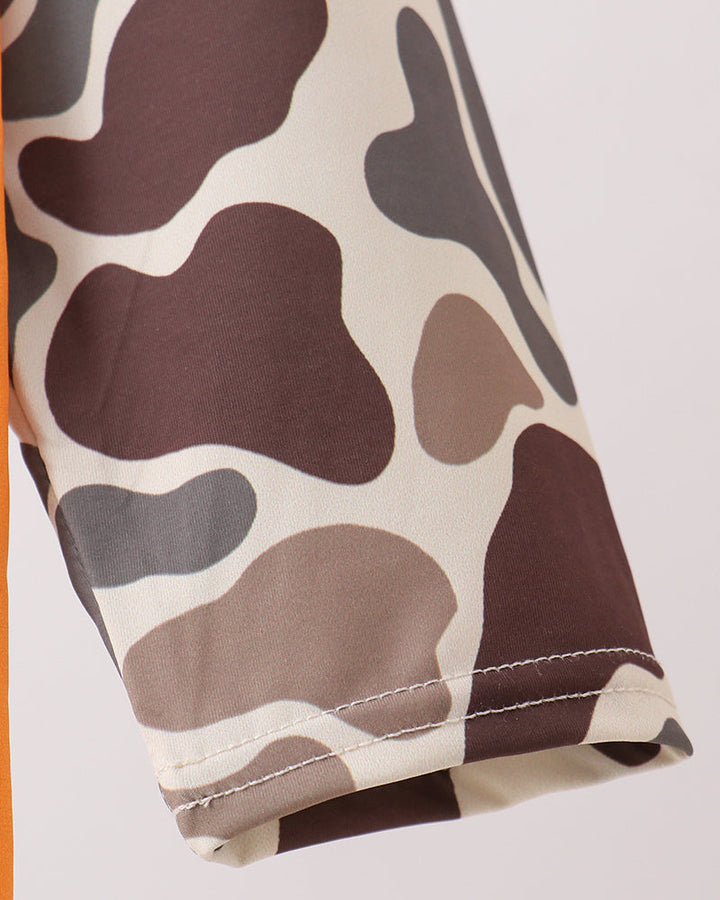 Close-up of a camouflage-patterned fabric with a white background