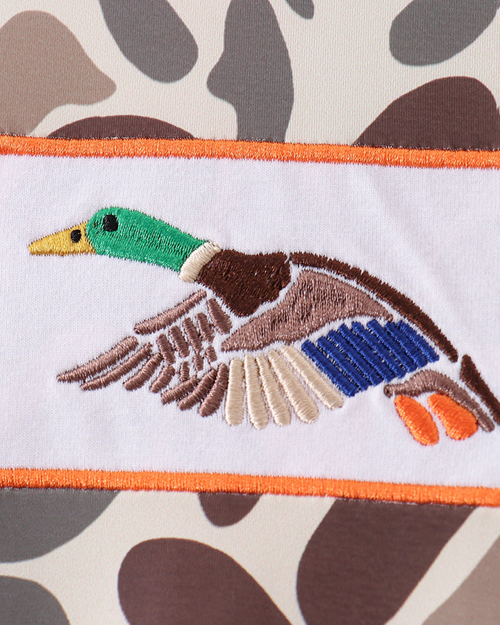 Embroidered duck design on a fabric with camouflage pattern