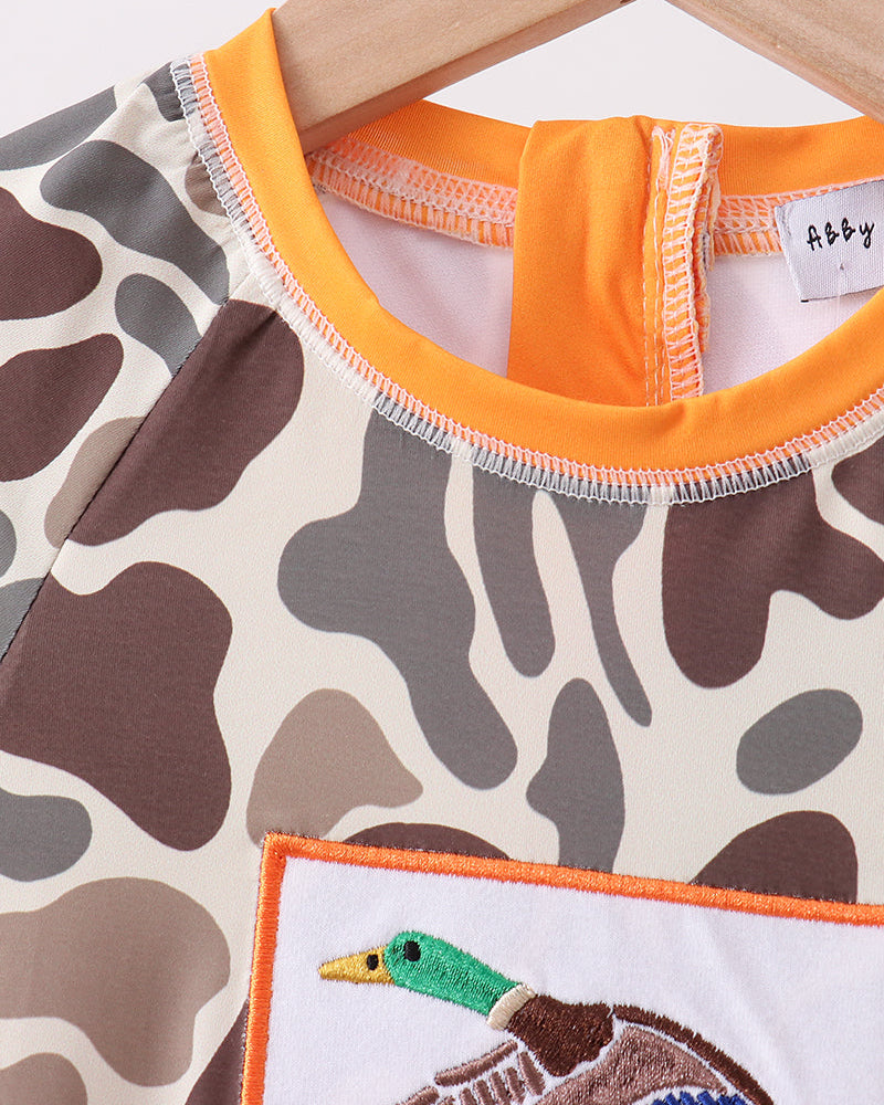 Swimsuit with camouflage pattern and embroidered duck design.