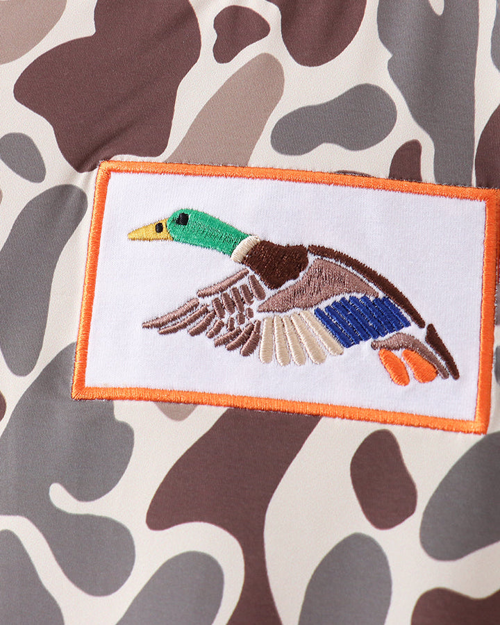 Embroidered duck patch on a camouflage-patterned fabric