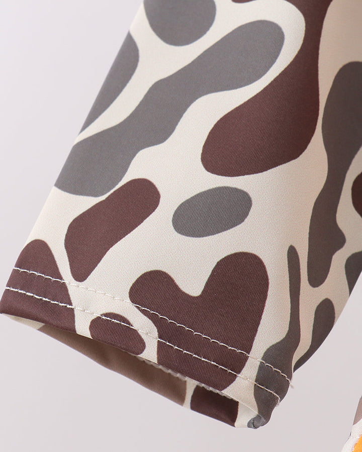 Close-up of a fabric with brown and gray pattern on a light gray background