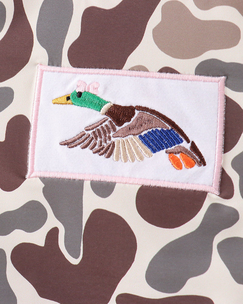Embroidered patch of a duck on a camouflage-patterned fabric background