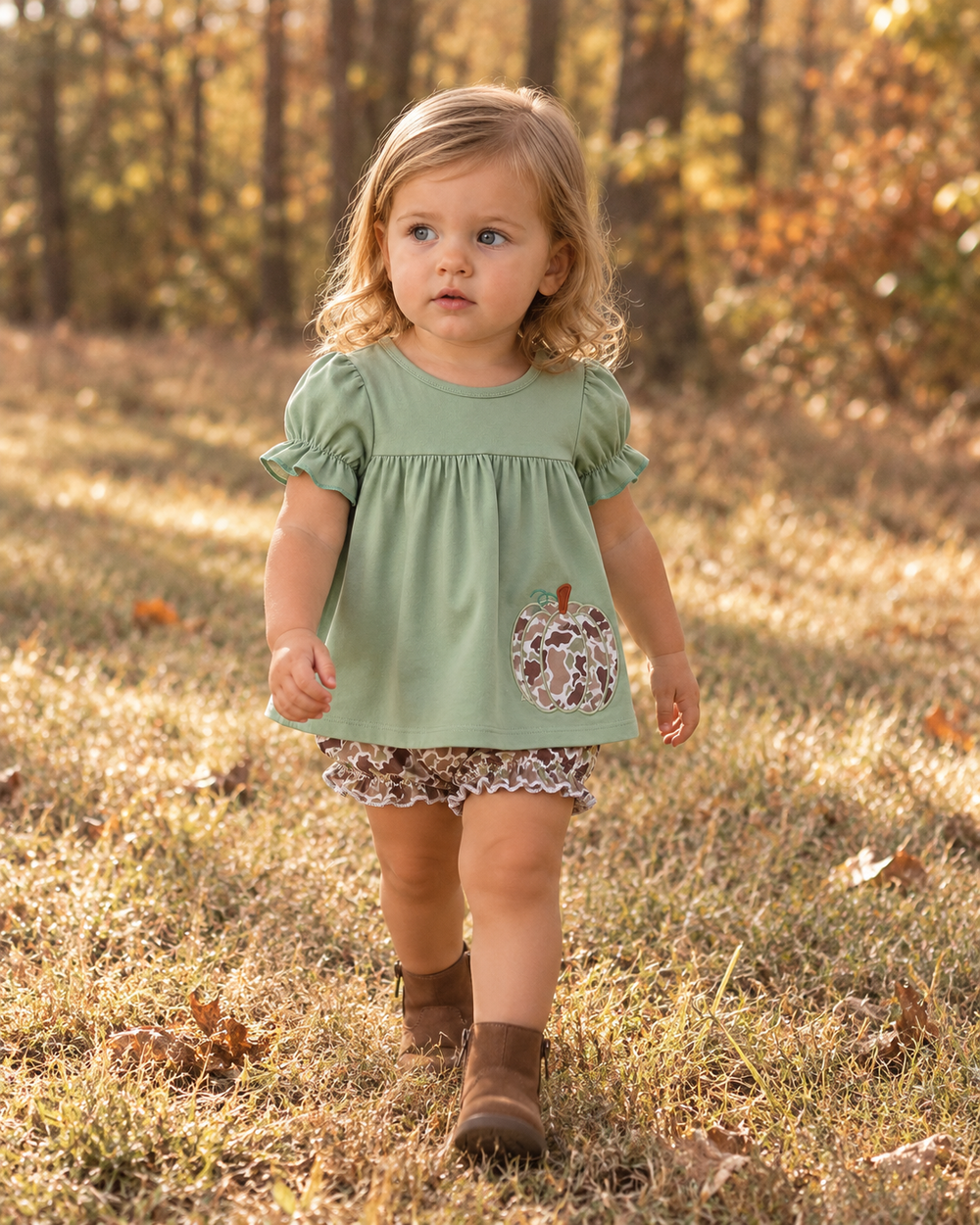 Toddler is walking in the edge of the woods