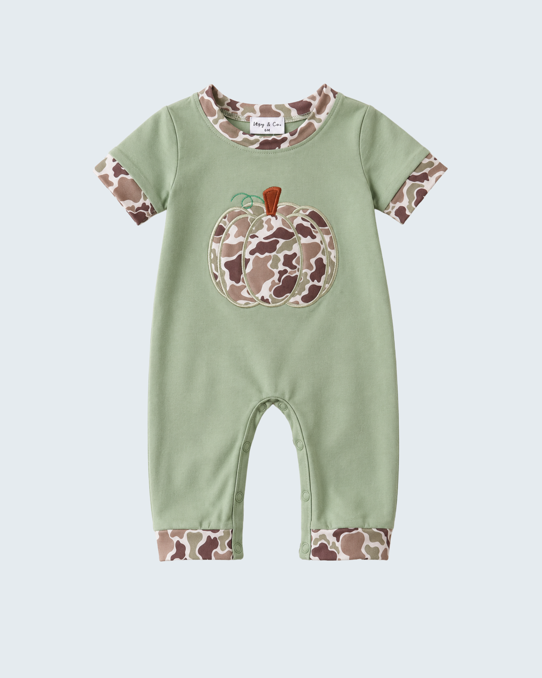 A baby short-sleeve romper in sage green, featuring a large applique pumpkin with a brown and beige camouflage pattern on the chest, matching camouflage trim on the collar and cuffs, and a camouflage pattern on the cuffed legs.