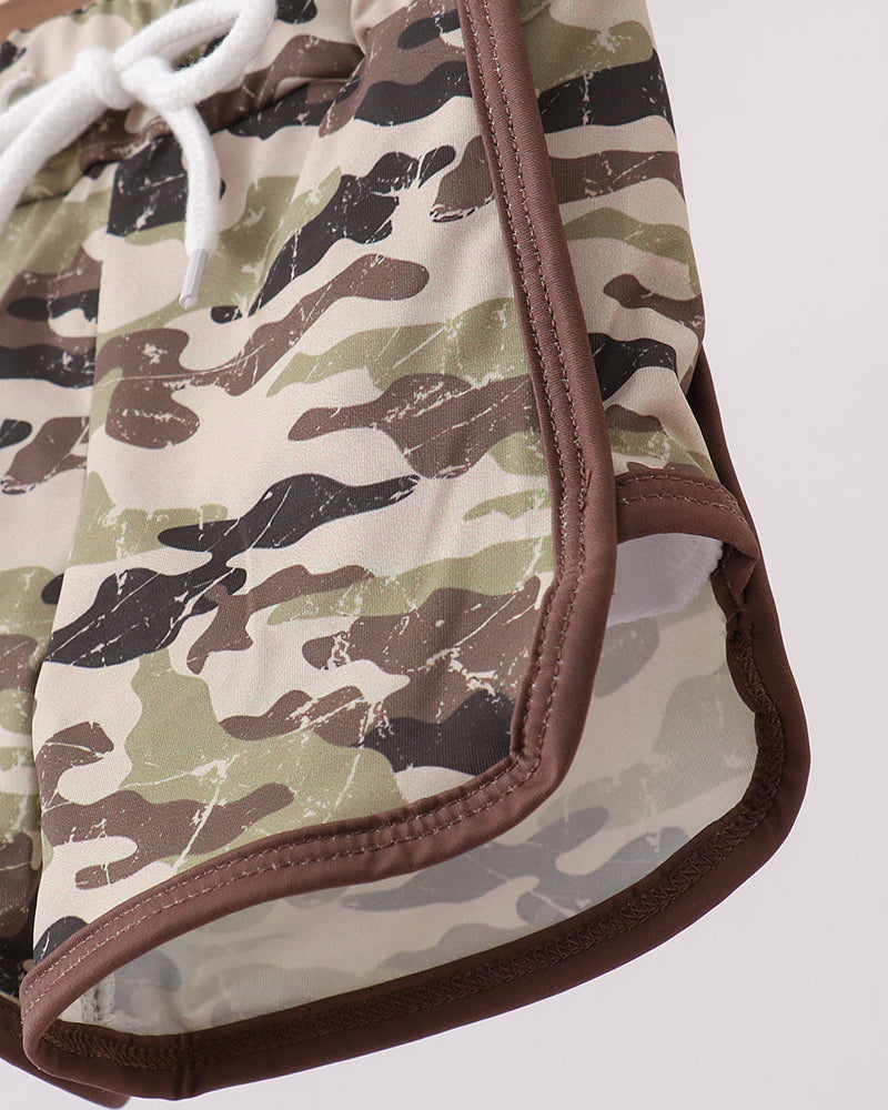 Camouflage-patterned shorts with brown trim on a white background