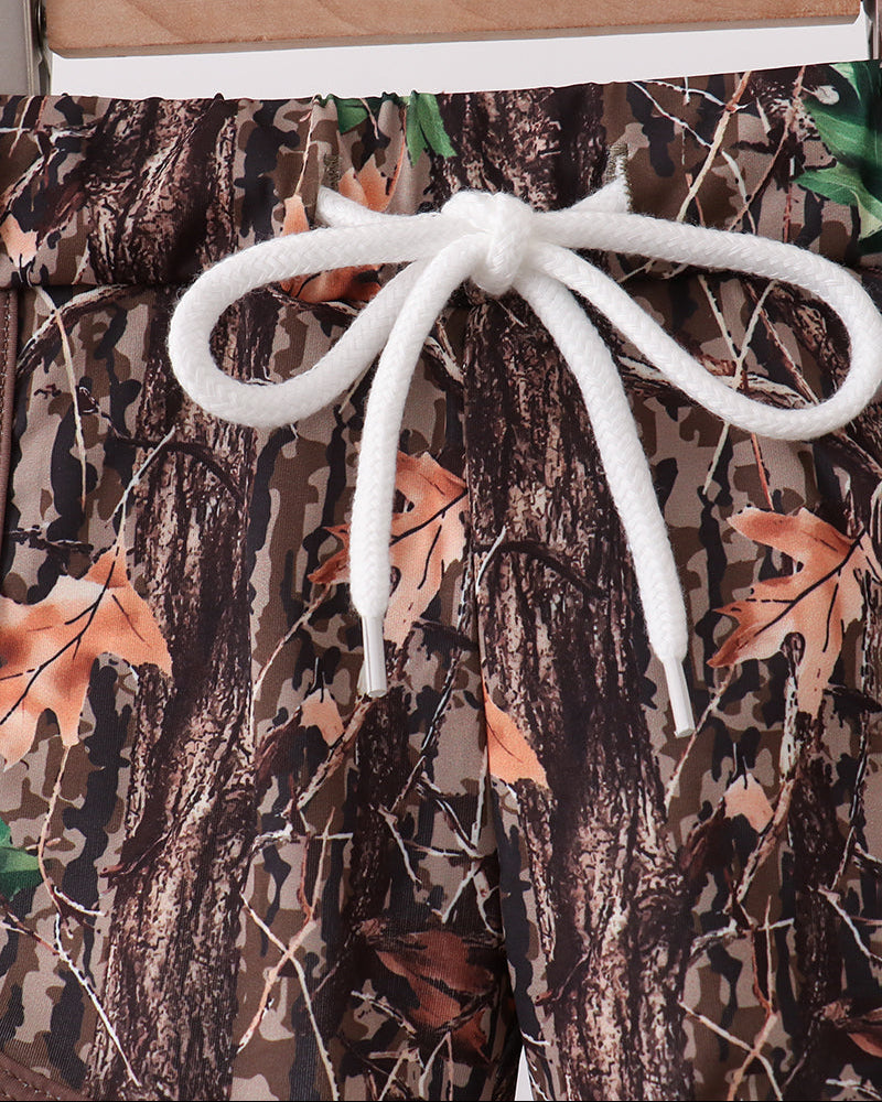 String tie on camouflage pants with a wooden stick.
