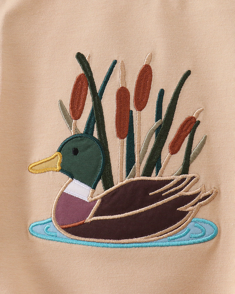 Beige romper with duck in water applique in teal, brown, and green