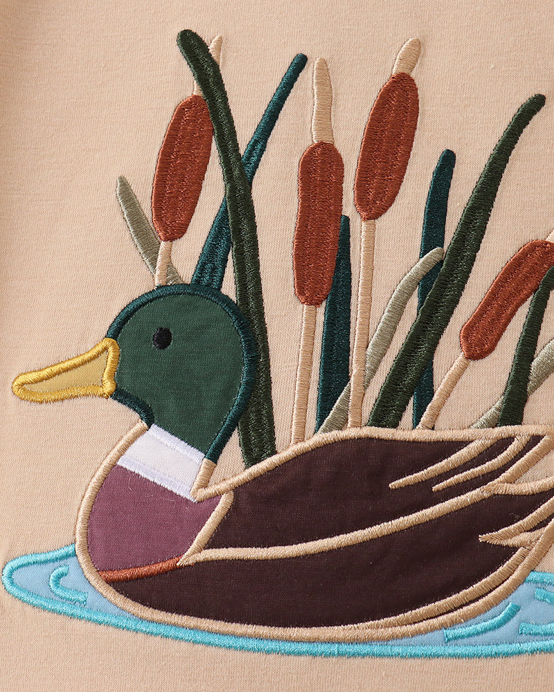 Beige T-shirt with stitched duck applique and colorful reeds