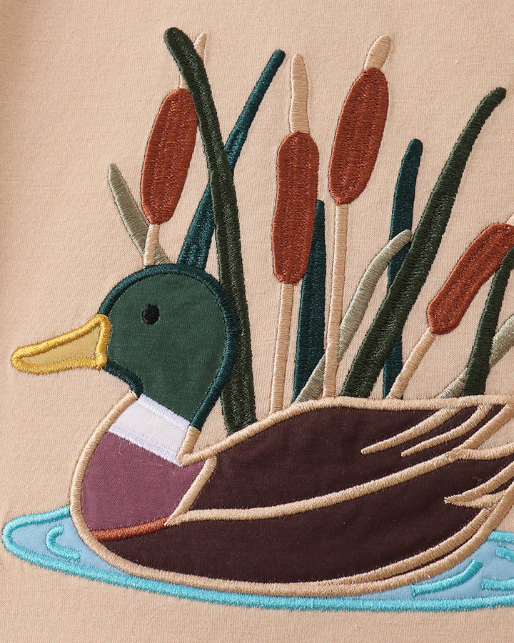 Beige T-shirt with stitched duck applique and colorful reeds