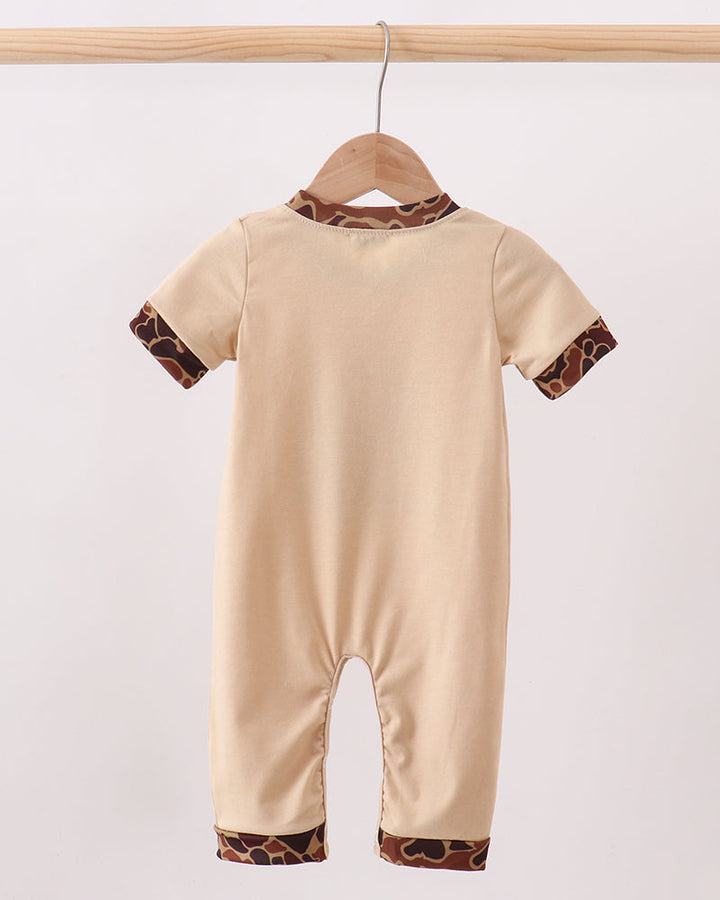 Beige short-sleeve romper with camouflage-trim cuffs and leg opening, front view