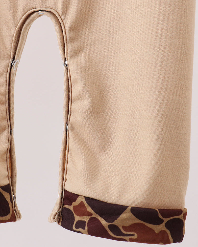 Beige romper leg opening with camouflage print hem trim detail