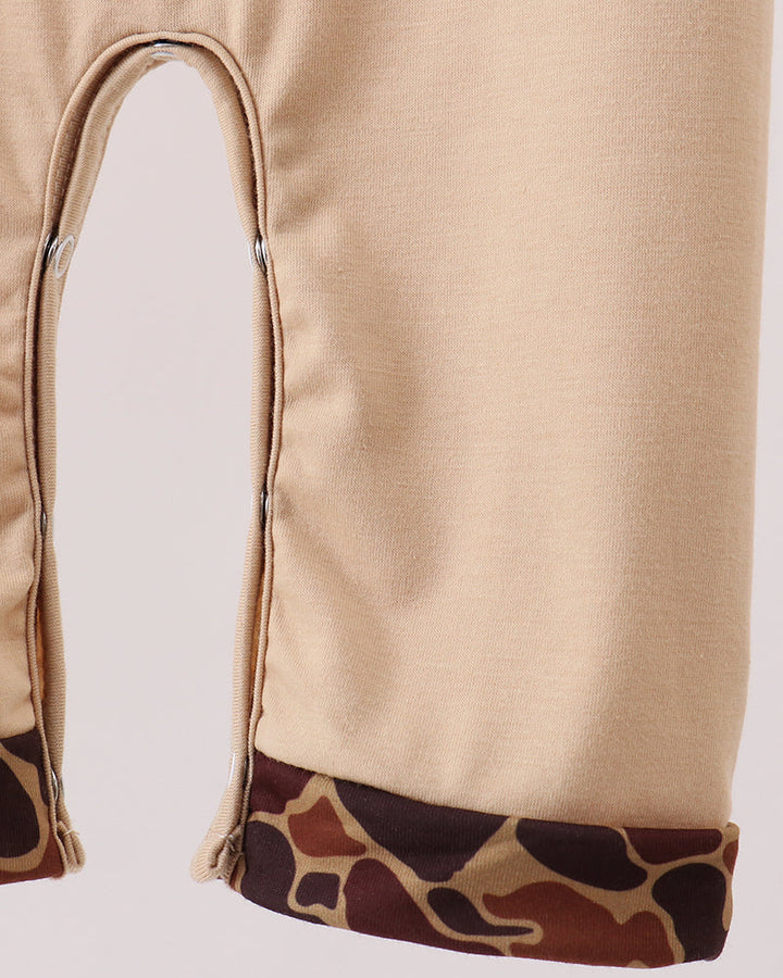 Beige romper leg opening with camouflage print hem trim detail
