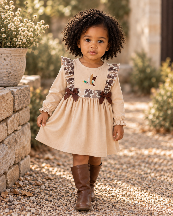 Toddle girl in dress with camo accents and tall brown boots.