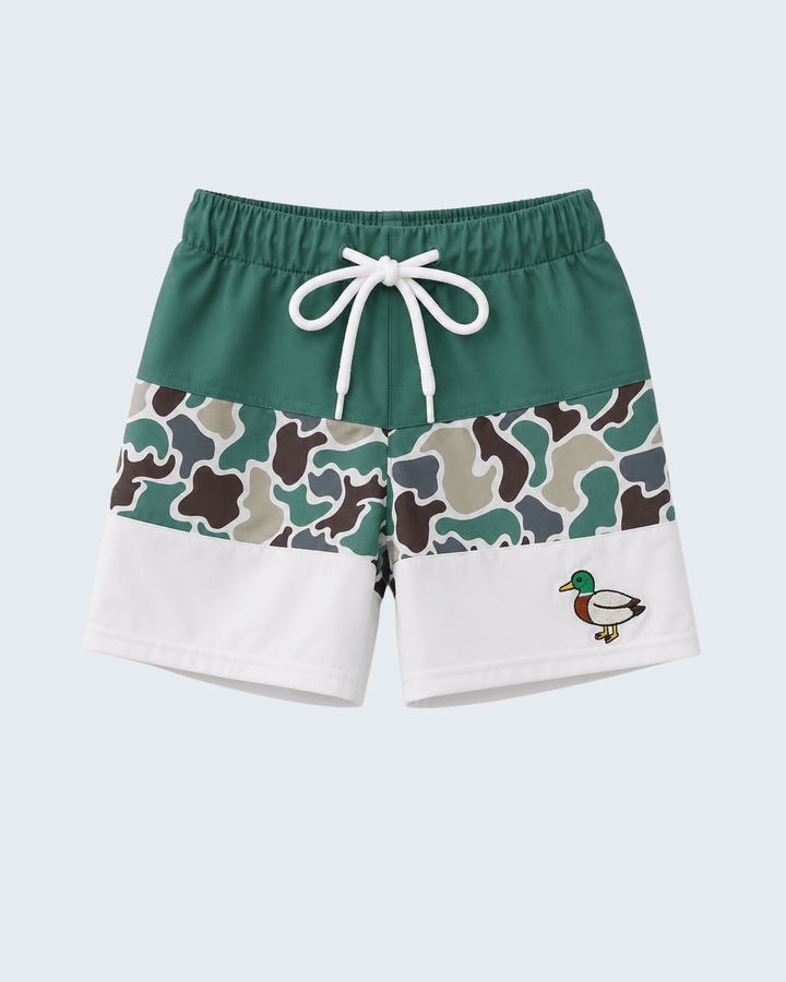 Green and white shorts with camouflage pattern and duck design on a light blue background