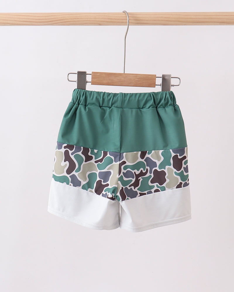 Green shorts with camouflage pattern on a white background