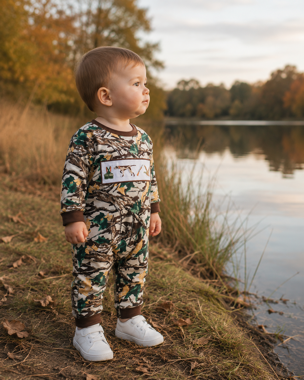 Camouflage hunting romper on toddler with chest embroidery patch and brown cuffs