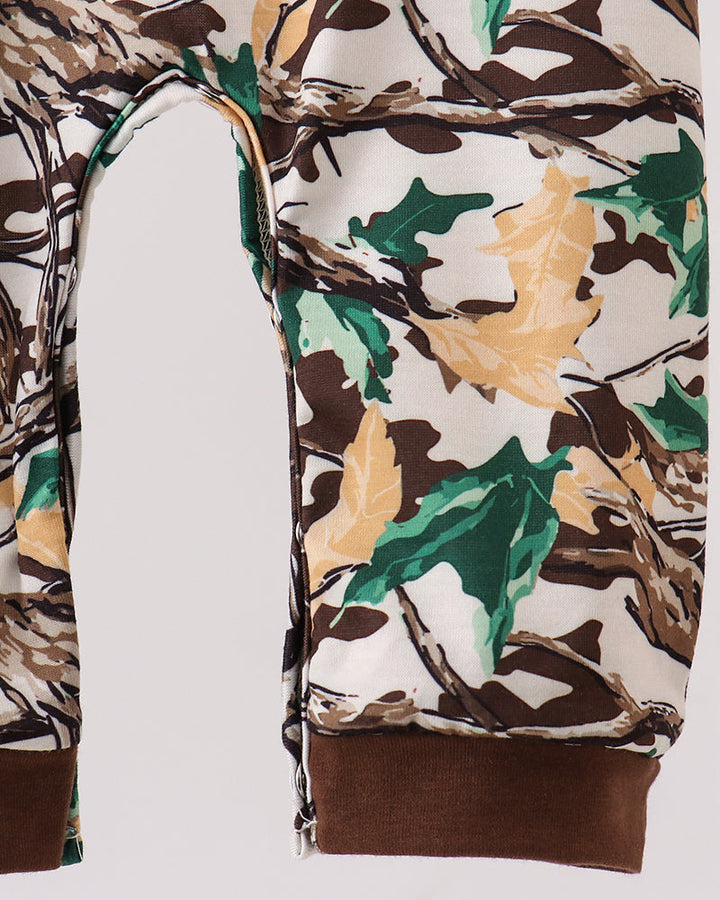 Camouflage romper with long sleeves and brown ribbed cuffs; side view