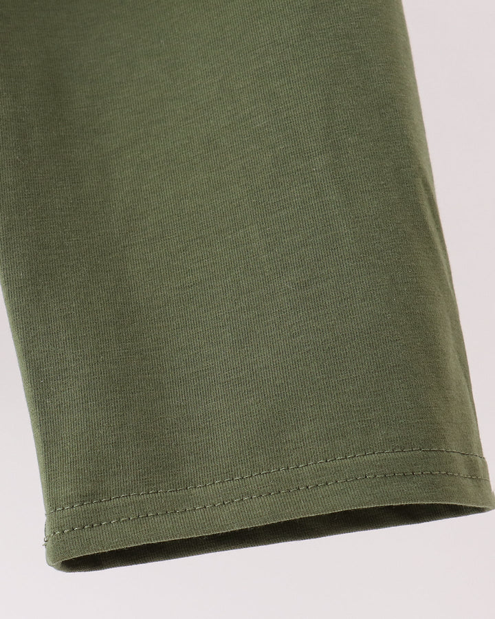 Close-up of an olive green knit fabric sleeve or cuff with neat hem stitching, shown against a plain light background.