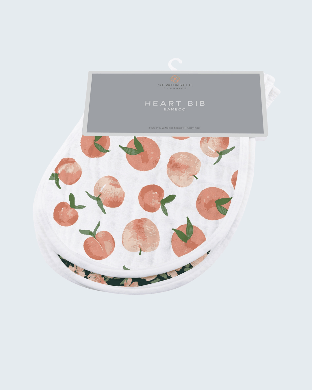 Heart-shaped bib with peach pattern on a light gray background