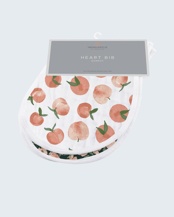 Heart-shaped bib with peach pattern on a light gray background