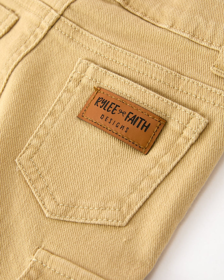 Khaki girls cargo pants with stitched pocket and leather brand patch