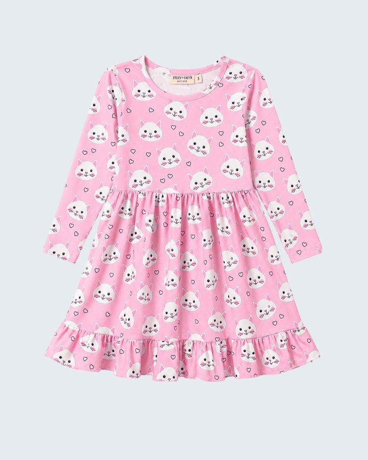 Pink dress with cat pattern on a light purple background