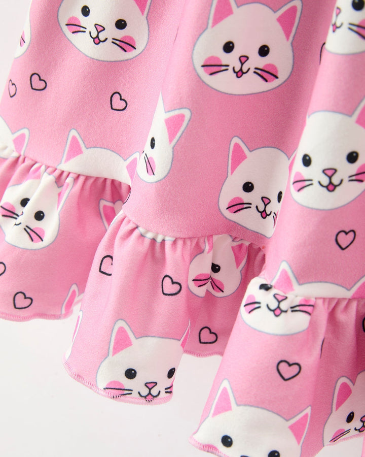 Pink shorts with cat face patterns on a white background