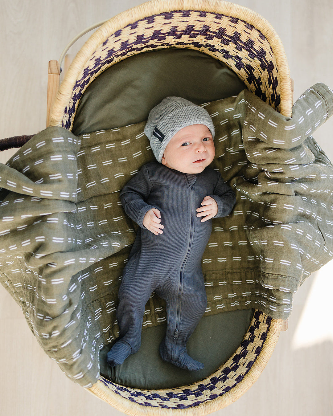 Charcoal ribbed cotton zipper romper on baby, front view with long sleeves