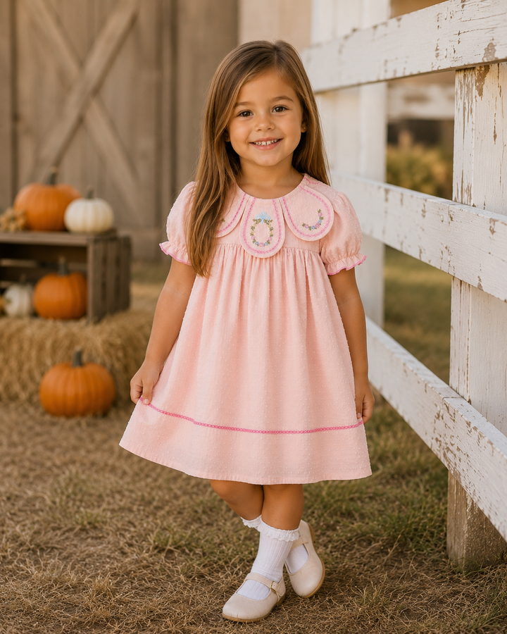 Blush pink petal-collar dress with embroidered neckline, short sleeves, dotted skirt