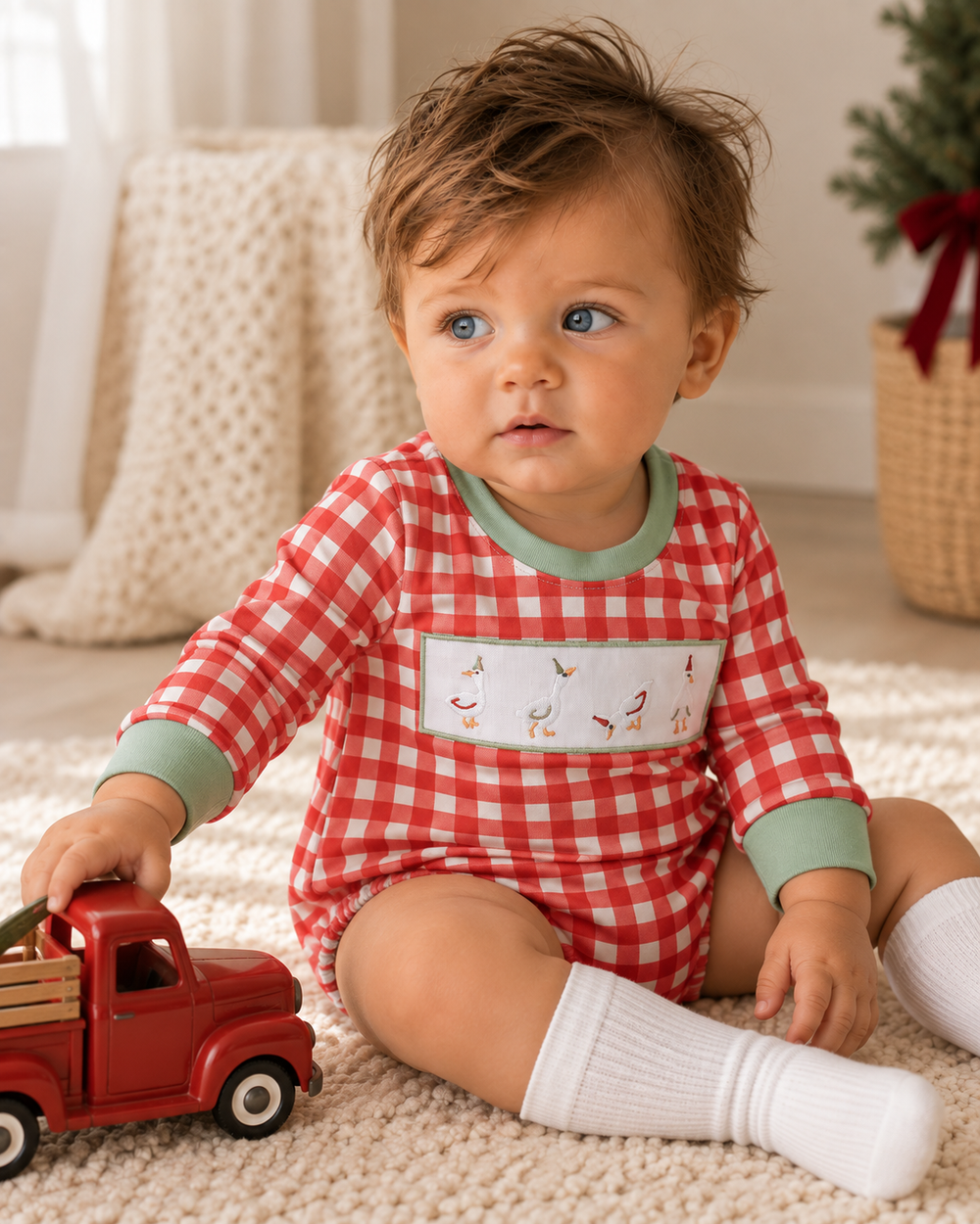 Red and white gingham bubble romper with duck-geese embroidery and green cuffs on baby