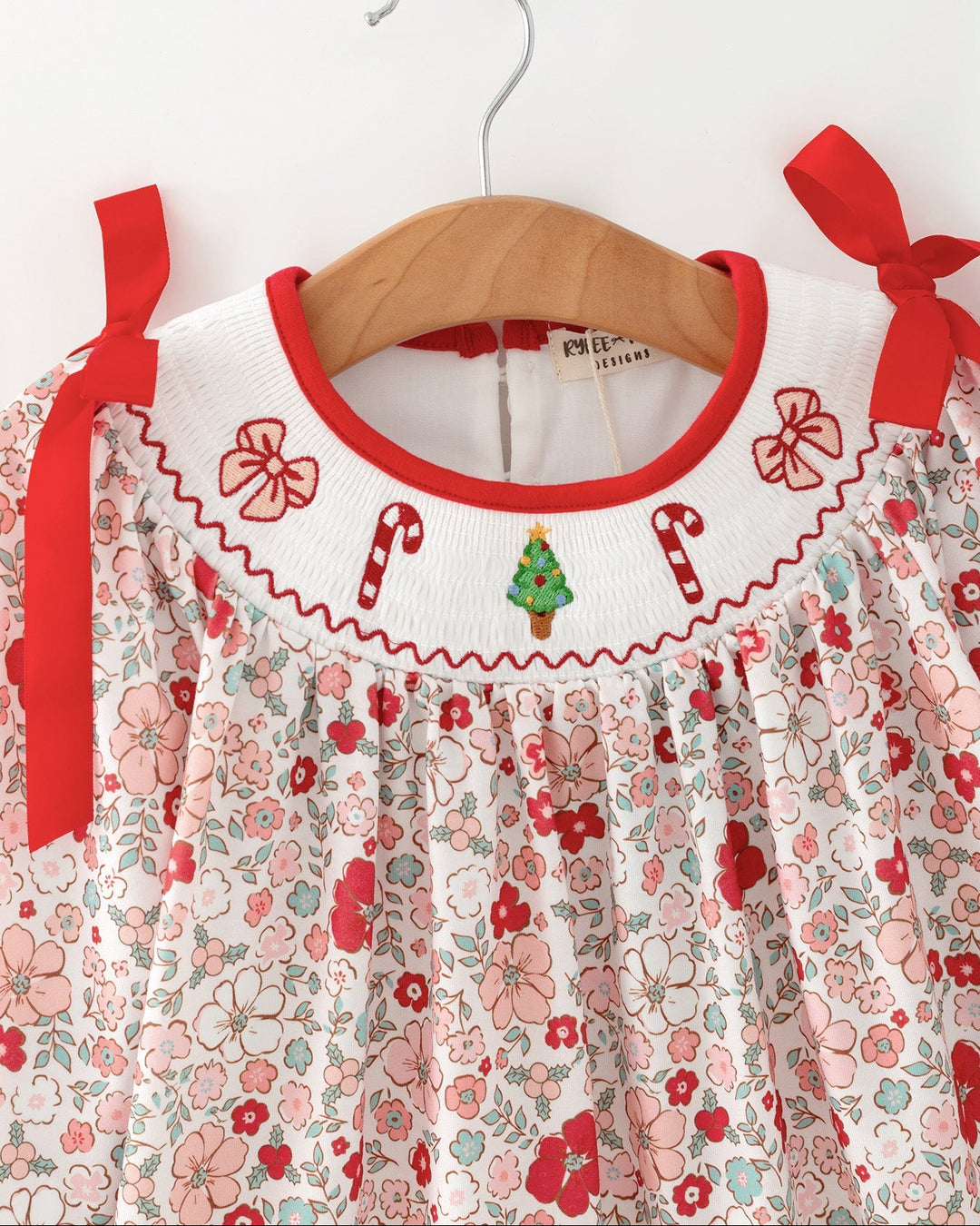 Girls floral dress with red-trimmed neckline and embroidered candy cane motifs