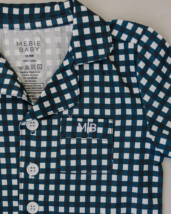 Blue gingham pajama shirt close-up with button placket and short sleeves