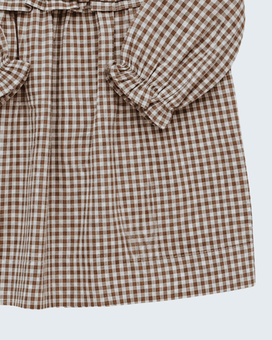 Brown-and-white gingham dress with cuffed long sleeves and ruffled bow detailing