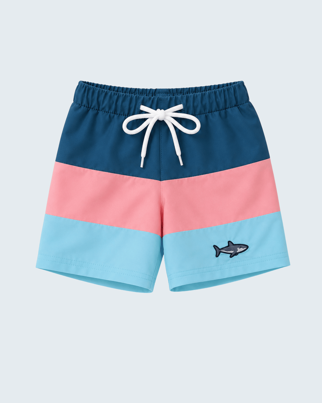 Color-blocked shorts with a shark design on a light blue background