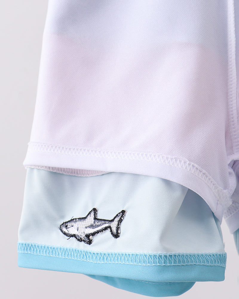 White and light blue swimsuit with shark design on a plain background